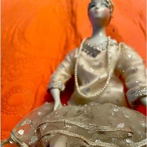 Porcelain doll elegantly attired